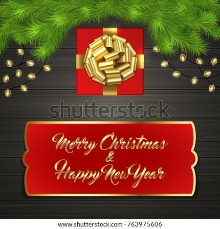 Christmas card with Cristmas fir tree branches, red square gift box with gold ribbon bow, garland on black wooden board. Greeting text Merry Chrismas and Happy New Year on red label with gold frame