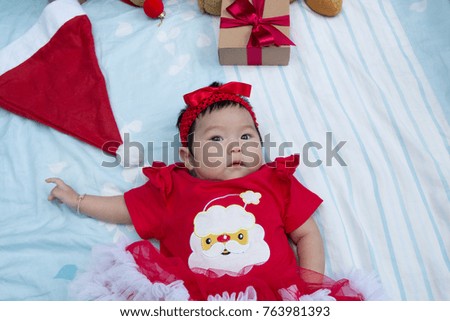 Cute baby with gift at Christmas tree