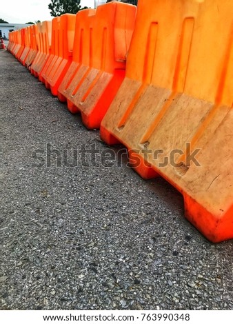 Orange plastic barriers blocking the road.