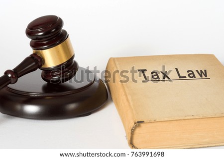 A gavel and a law book with tax law