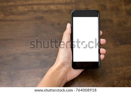 Woman hand presenting smartphone with empty white screen for montage your texts or pictures