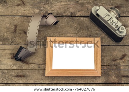 Old wooden background with isolated place under the photo and retro camera elements