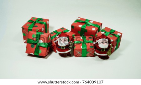 A glitter christmas decorations : santa claus and a present box on a white background. Concept for Christmas celebrations.