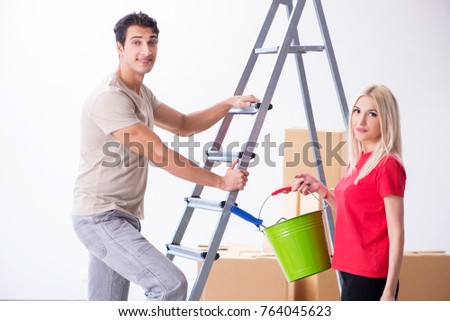 Young family doing painting job during home renovation