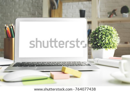 Contemporary workplace with empty white laptop monitor, supplies and other items. Close up. Creative designer office, education, occupation, freelance and lifestyle concept. Mock up 