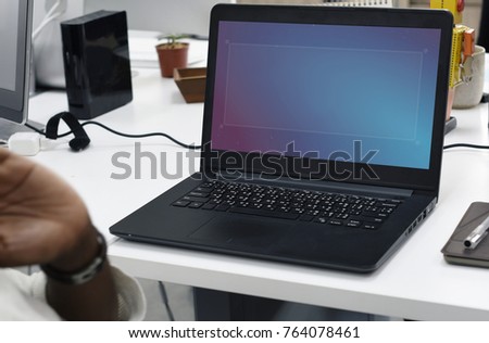 Man working in an office with his laptop