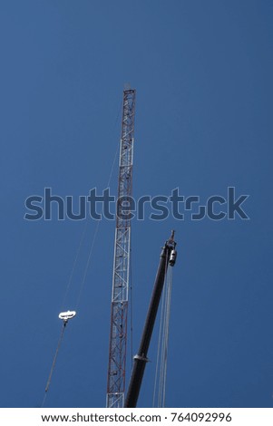 Construction Tower Cranes with clear blue sky in the background