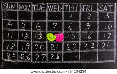 Freehand white chalk doodle sketch of blank monthly grid timetable schedule on black chalkboard
