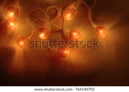 Electric garland with red light bulbs covered with frost.