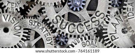 Macro photo of tooth wheel mechanism with SUCCESS concept letters