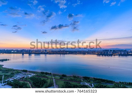 cityscape and skyline of downtown near water of chongqing at night 