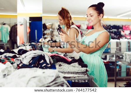 Positive young women shopping panties at the apparel shop