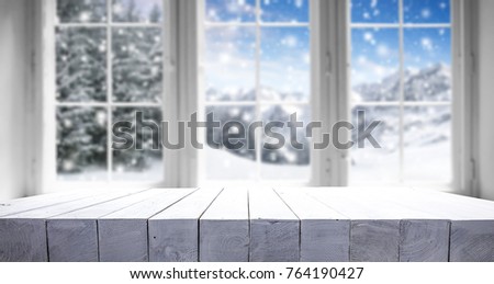 Desk of free space for your decoration. Winter window with landscape and snow .