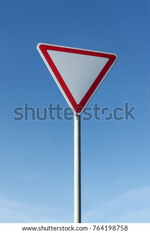 Give way sign on blue sky background