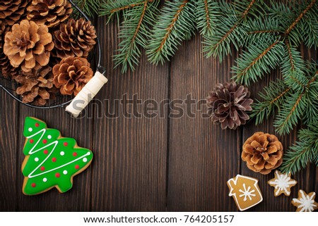 Christmas or New Year background. Fir-tree branches , Christmas tree toys, stars, snowflake and cones on dark brown wooden background. Selective focus. Top view. Copy space.