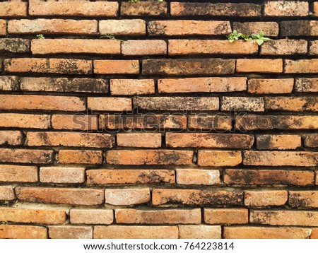 Old brick wall background, texture of red stone blocks.