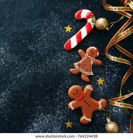 Christmas or new year background. Different shapes of gingerbread cookies and decorations on a wooden backdrop. Copy space and top view.