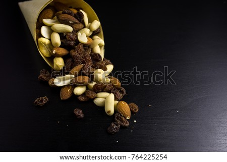 mixed peanuts on black background. top view. no photoshop used. copy space for text.