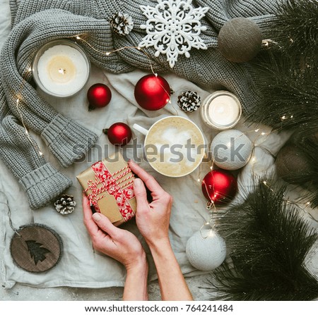 Women's hands hold a present .Winter cozy Christmas concept. Flat lay, top view