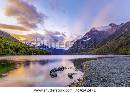 Lake Gunn at sunrise with beautiful sun rays, Fiordland, South Island, New Zealand