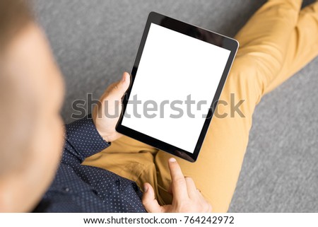 Man holding tablet in vertical position.