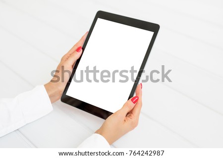 Woman holding digital tablet in vertical position. Screen mockup.