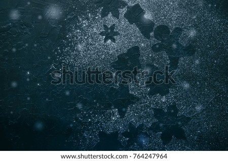 Different shapes of silhouettes on a black stone background.
