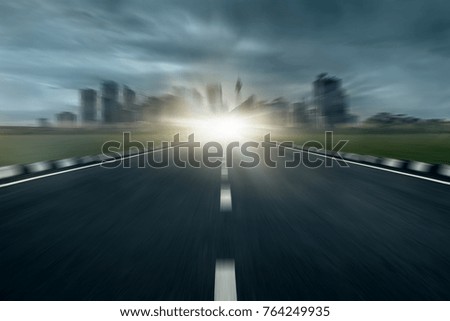 dramatic zooming asphalt road with modern cityscape skyline, motion blur highway roadside with urban city skyscraper stormy day