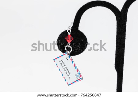 one red white and blue Dear Santa earring