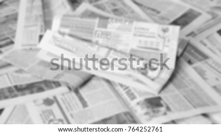 Newspapers. Bunch of old journals on horizontal surface. News and headlines on the grunge paper. Background texture, pattern for retro  design. Wrinkled newspapers blurred,  side view, close up