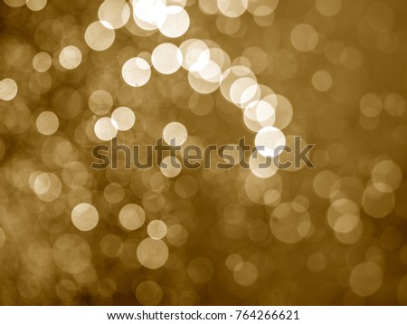 Blurred light or Bokeh of water fly and lights on gold background