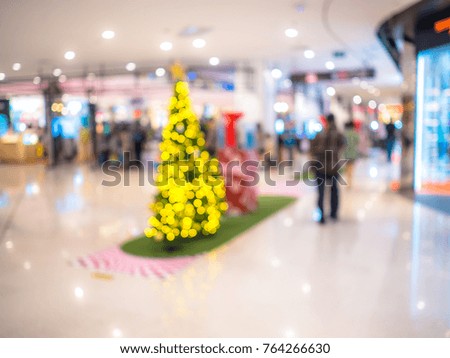 Christmas tree in shopping mall or department store with blurred background and bokeh light