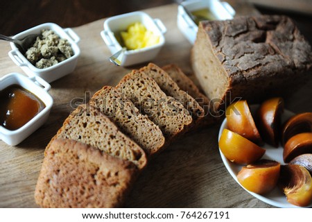 Fresh homemade unleavened bread on the leaven is sliced on wooden board. Serving of breakfast