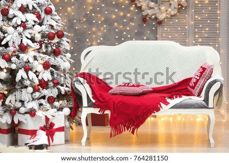 Gorgeous christmas tree in luxury interior with gifts in classic white and red colors. New year at home.