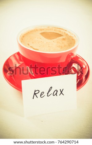 A Red Cup of Cappuccino and Notes Relax on Light Rustic Table From Above. Toned Image. Selective Focus.
