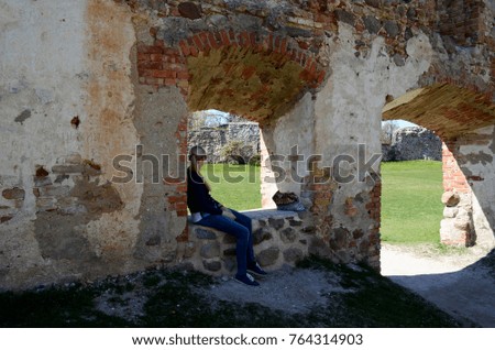Girl sitting in the window of a castle