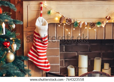 Striped sock for gifts on a fire-place. Conception of New Year