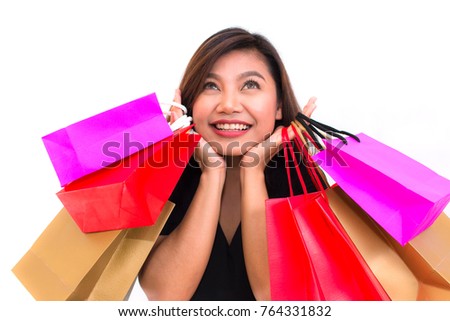 Beautiful young Asian woman with colorful carry shopping bags in her hands smile and happiness. over a white background.