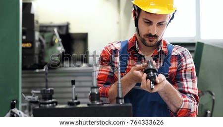 Male worker and quality control inspection in factory
