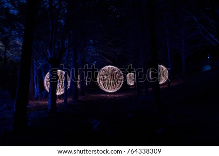 Spheres of light made in the dark forest with lightpainting technique