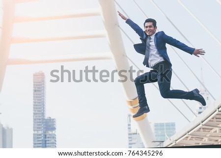 Businessman jumping for joy celebrating successful goal in the city, success Business concept