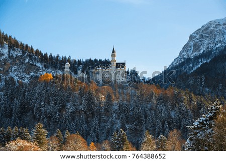 Splendid scene of royal castle Neuschwanstein and surrounding area in Bavaria, Germany (Deutschland). Famous Bavarian destination sign at sunny snowy winter day.