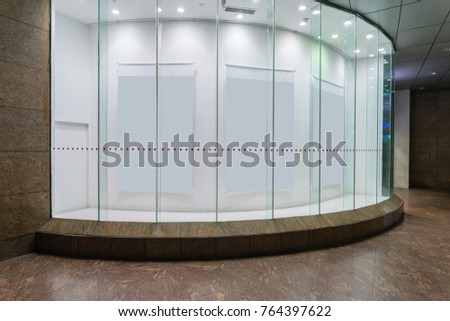 Empty paper billboard in the display window of modern shop
