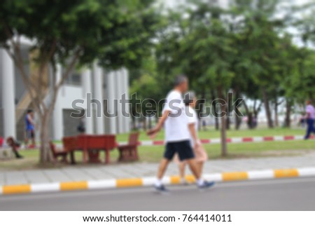 Burred Photo of elderly people walking exercise at park outdoor.for care Health In the evening.
