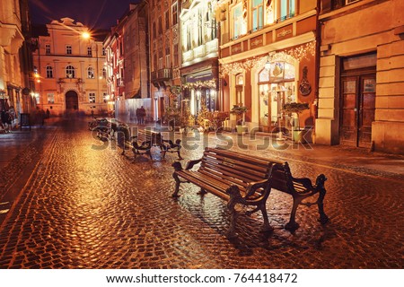 Evening street with benches and lanterns. Night European city