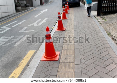 Orange traffic cones on pavement