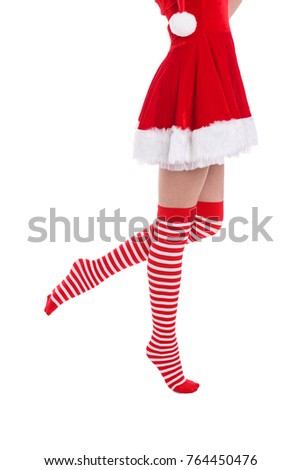 The girl's leg is raised and stands on one leg on a white isolated background