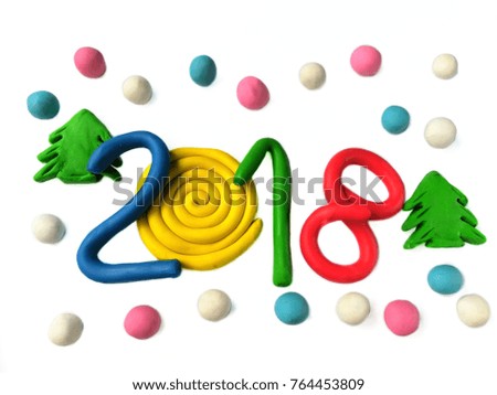 Colorful plasticine clay made beautiful numbers year 2018,a number 0 creates roll shape decorated a
Christmas green tree and snow covered on a white background