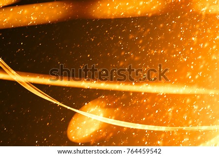 Xmas Gold sparkles or glitter lights. Christmas festive golden background. Defocused lines bokeh or particles. Template for design
