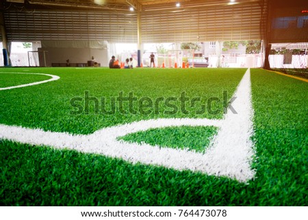 White Corner Line of an indoor football soccer training field with blurred background for soccer backdrop and sport concept design.